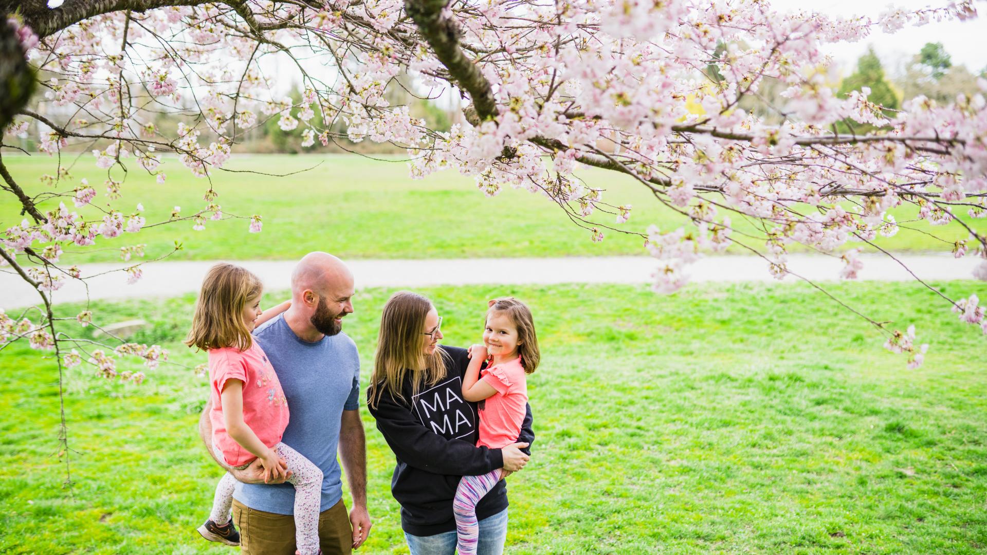 family in park cherry tree