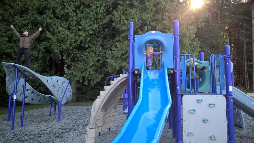 child playing in playground slide ocean view park